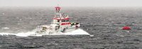 Der Seenotrettungskreuzer NIS RANDERS nähert sich einer im Wasser treibenden Rettungsinsel. (Quelle: DGzRS)